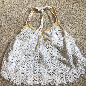 Four white tank tops